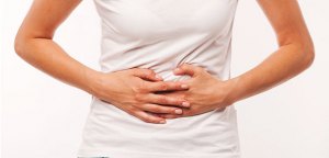 Woman heaving belly ache, on white background